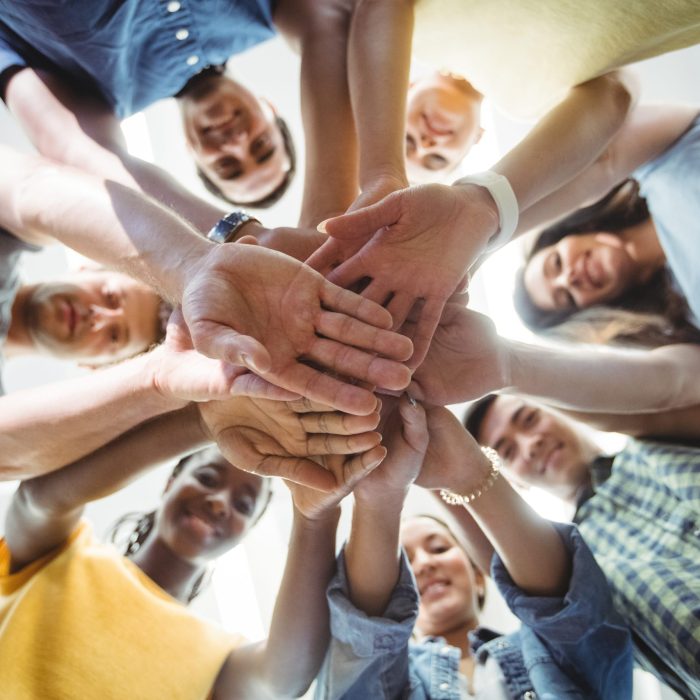 Close-up of business executives with hand stacked in office